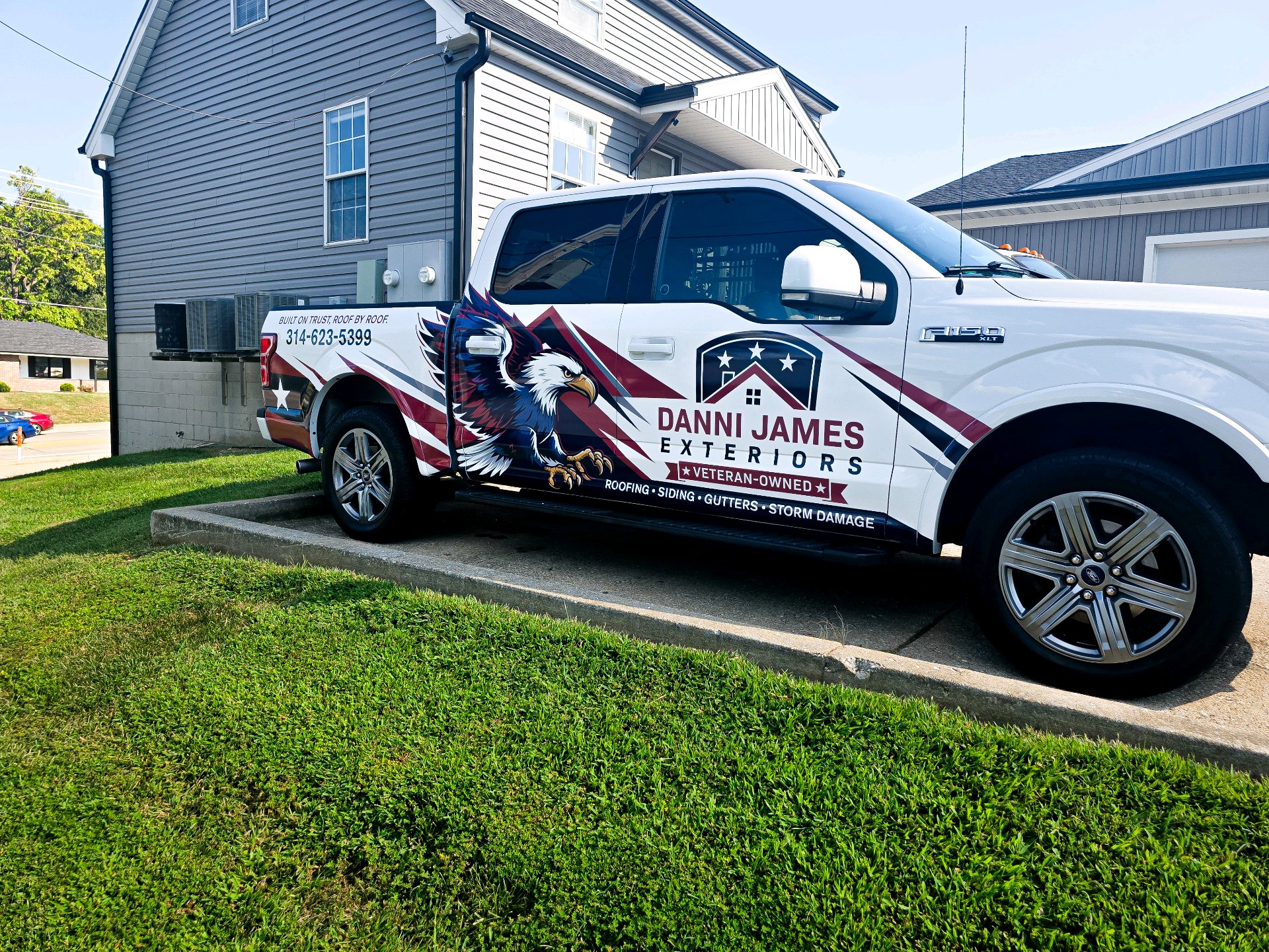 Danni James Exteriors work truck at a job site